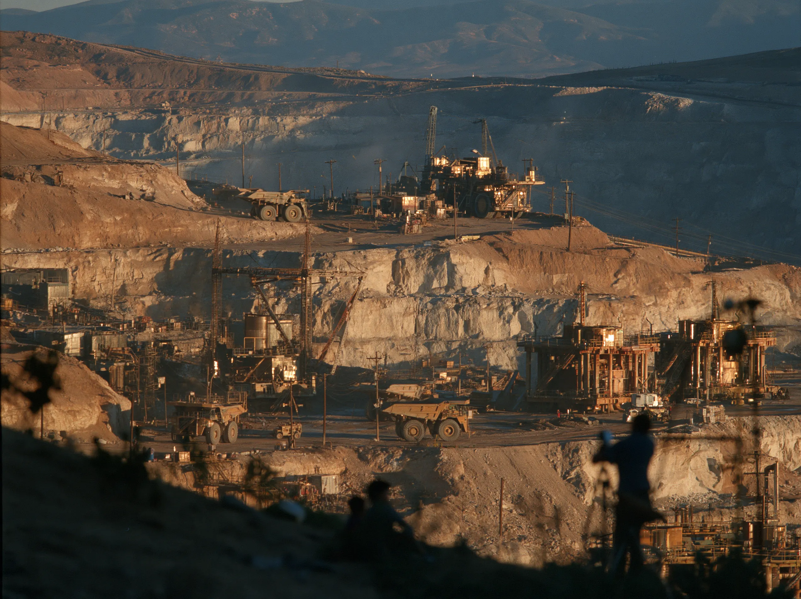 A sunlit terraced mine, fading into a white page