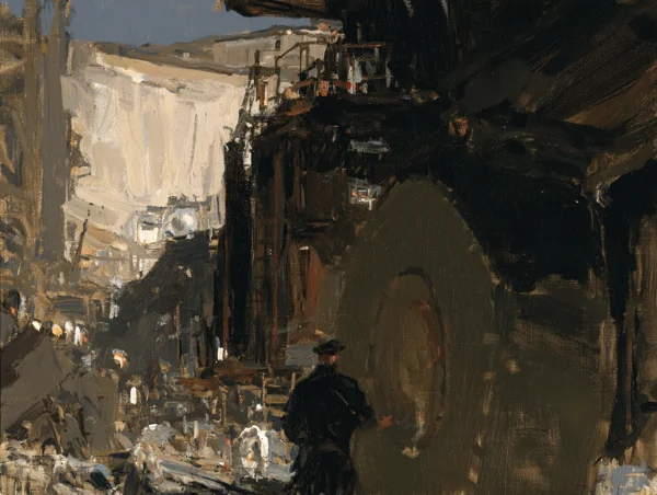 Small figure standing beside an immense mining truck wheel